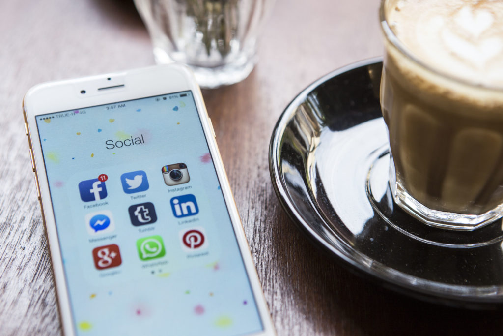 all popular social media icons and coffee on a table