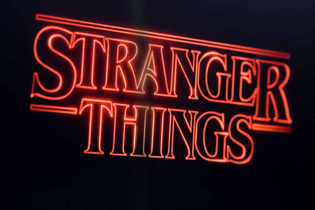 A red neon sign reads "Stranger Things"