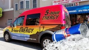 five hour energy truck parked outside of store with a redbull energy drink overlay on the image