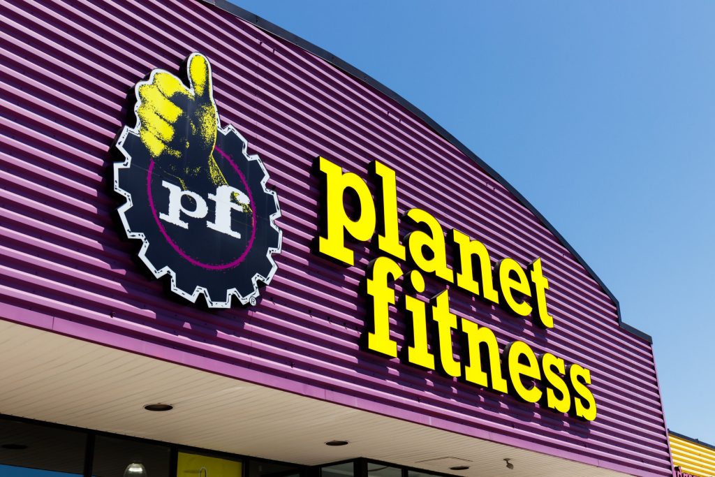 outside of planet fitness gym showing their logo